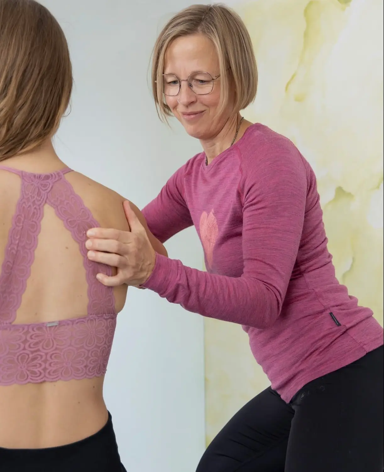 A female physiotherapist treating a patient's back
