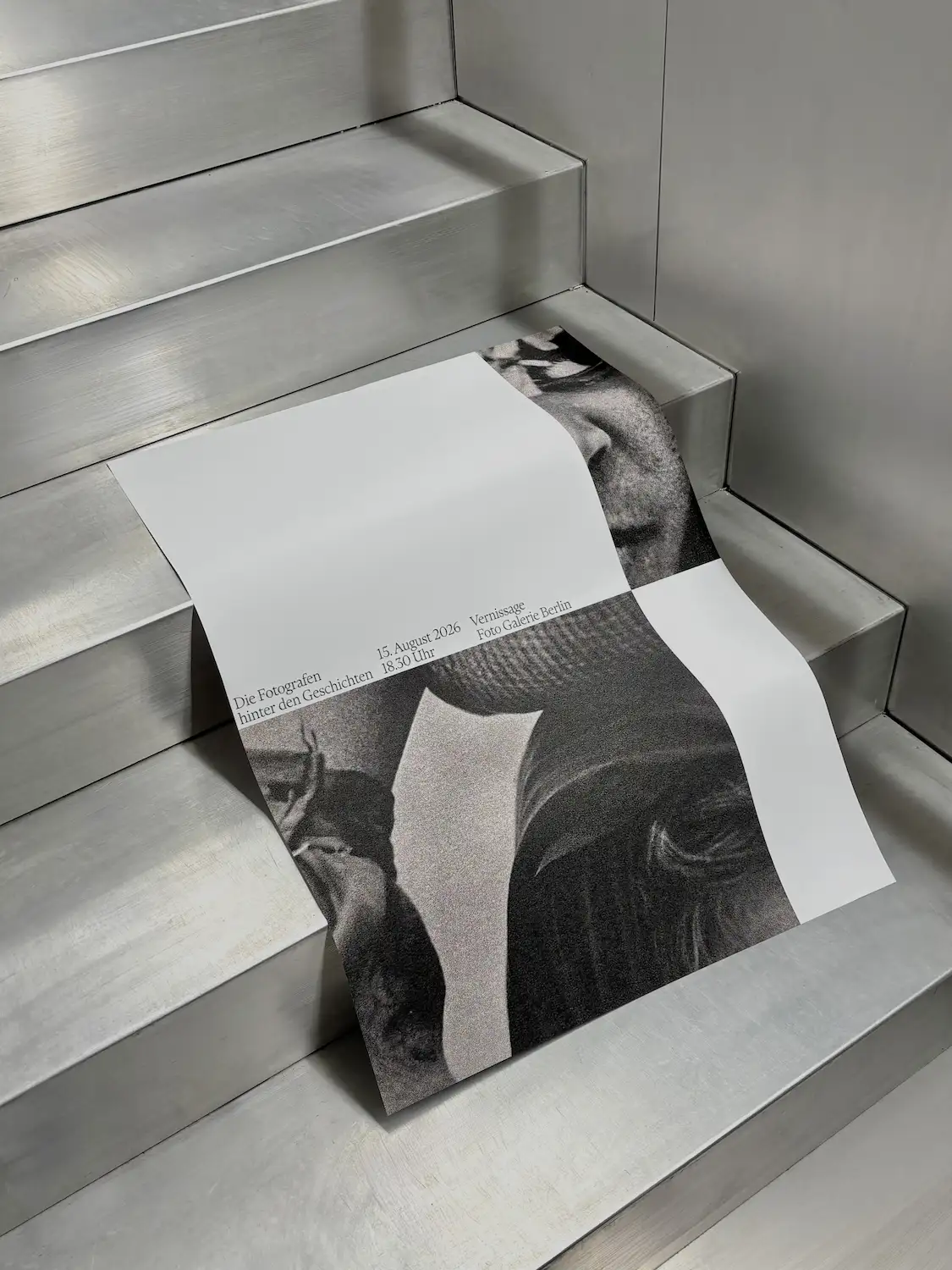 a poster with a black and white photograf of a girl on it, laying on stairs